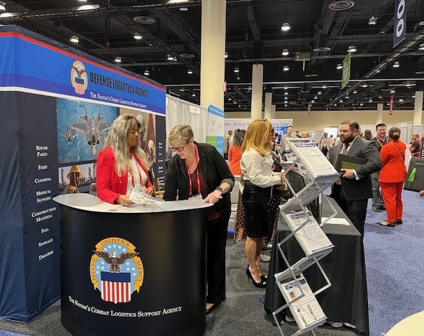 Donna Brino-Blackwell, Janel Thompson, and AnnaMarie Meagher in DLA Small Business Booth Donna Brino-Blackwell, Janel Thompson, and AnnaMarie Meagher in DLA Small Business Booth